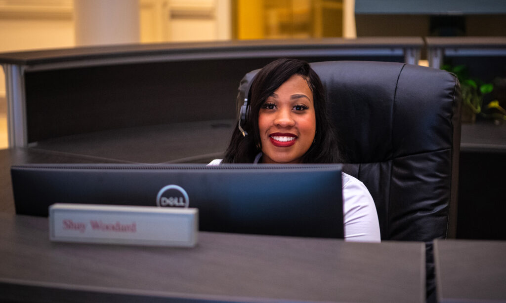 Customer service woman smiling at desk in City Hall rotunda