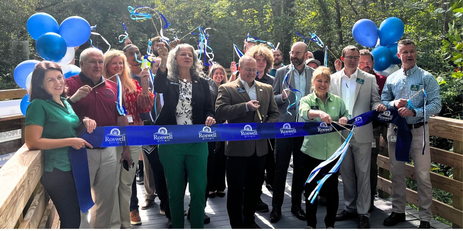 This is a photo of Roswell City Council and staff celebrating the completion of renovations on the Big Creek Greenway Boardwalk.