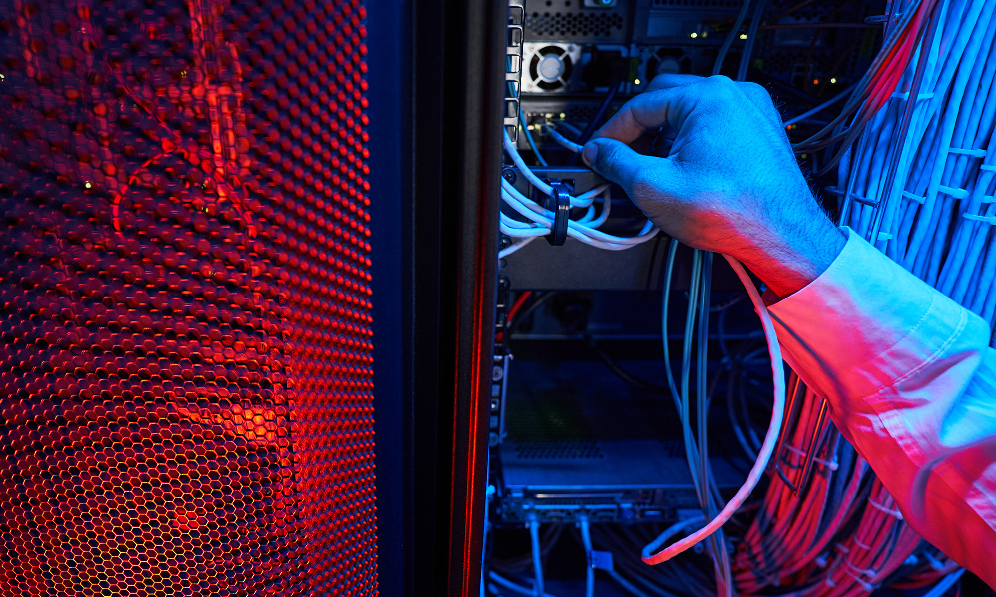 Hand Plugging Computer Cables Into Server