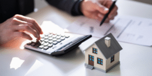 Graphic shows a person with a calculator and a mimi house.