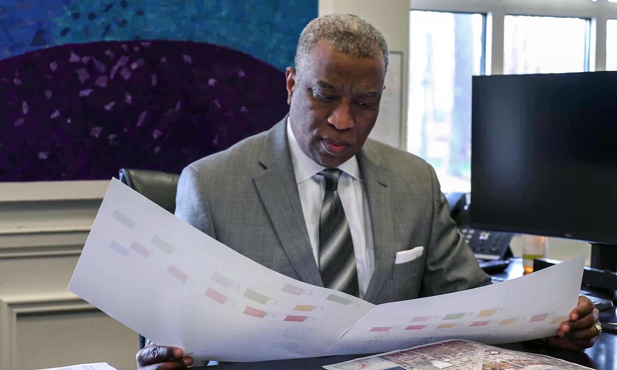 Randy Knighton Reviewing Documents at his desk