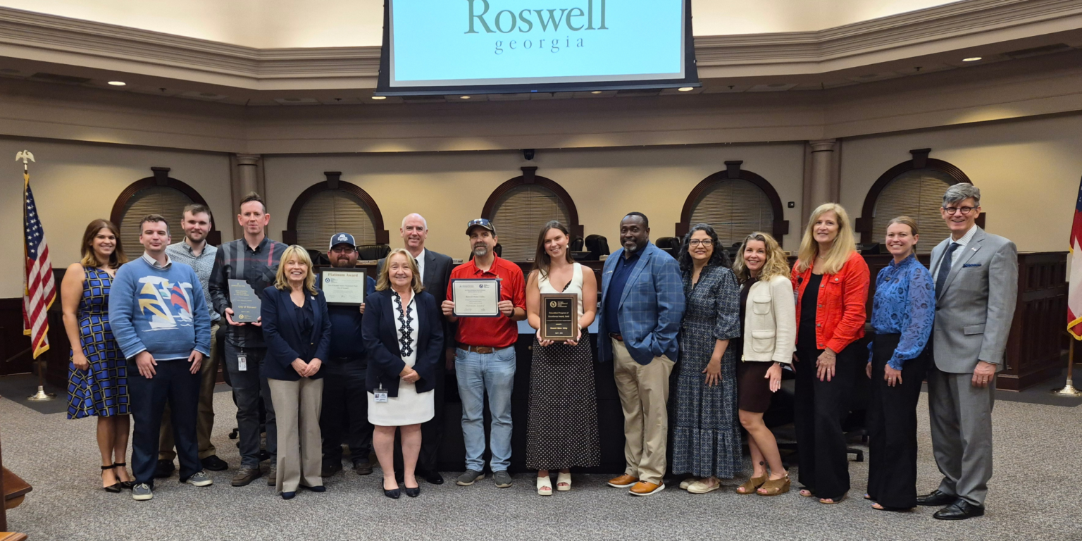 Photo of City Council, Mayor, and staff posing with awards.